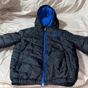 Hooded Boys puffer puma coat size 7 black on the outside with blue soft lining.
